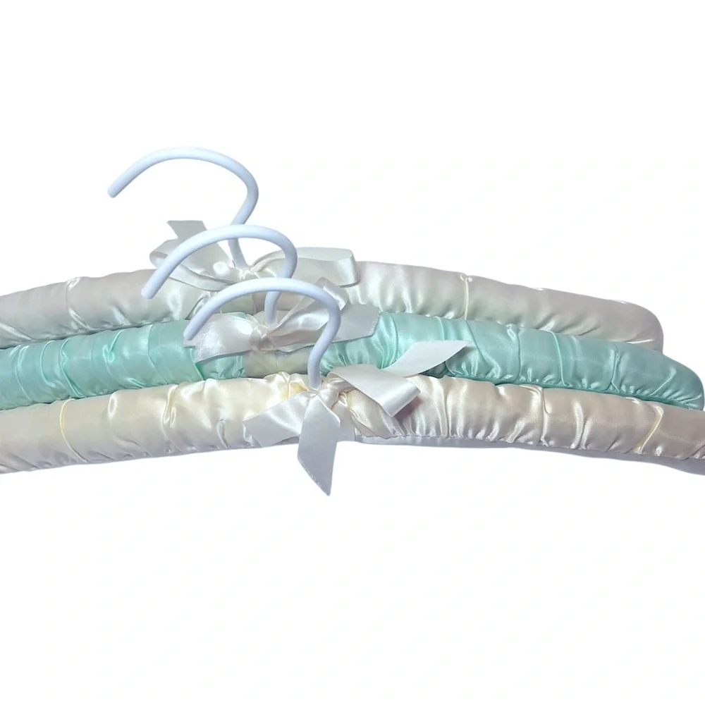 Three Luxurious Padded Satin Hangers-2 Cream and 1 Soft Blue Hanger.
